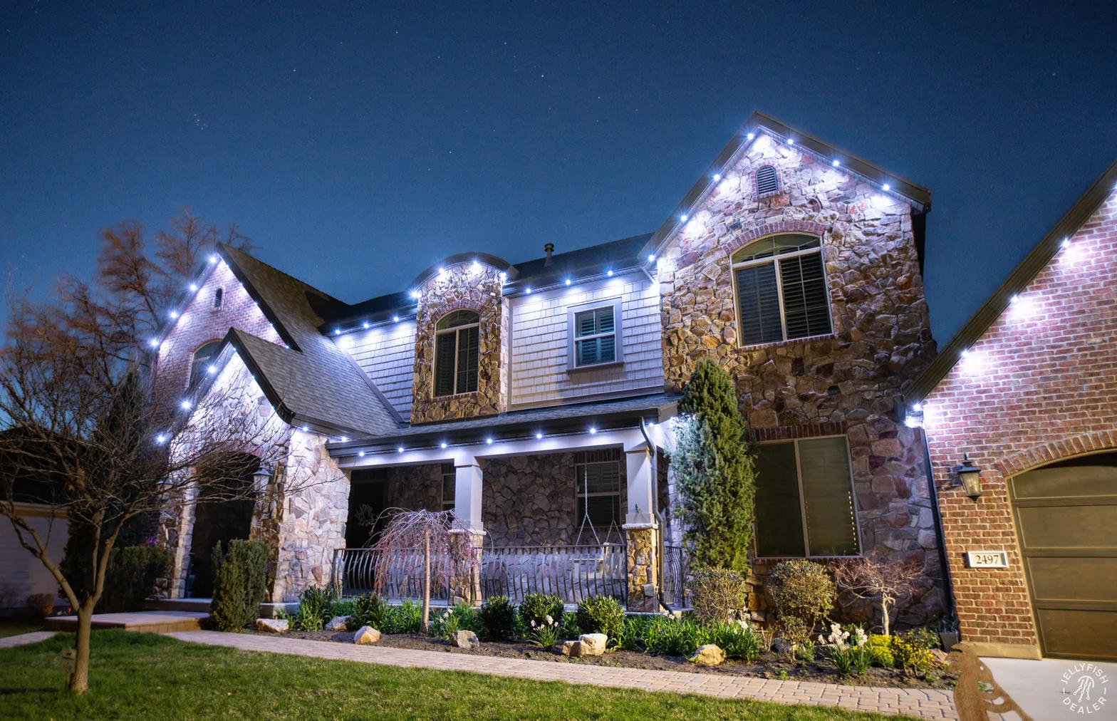 Crew installing holiday lights on a home roofline